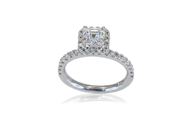 This halo style ring - Delora - features an Asscher cut diamond claw set in centre surrounded by brilliant cut diamonds in the halo and down the band.