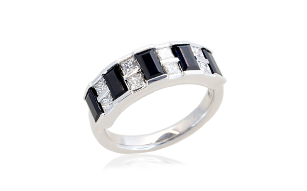 Ladies dress ring has alternating princess cut white diamonds and baguette Australian blue sapphires all channel set across top section of a wide band.