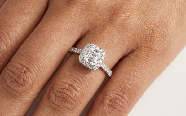 Asscher cut diamond halo ring on hand